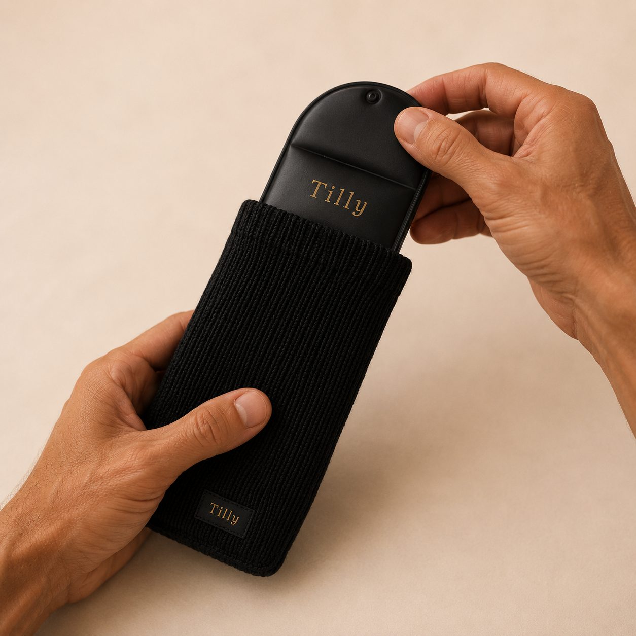 Hands sliding Tilly cooling pack into black knit sleeve